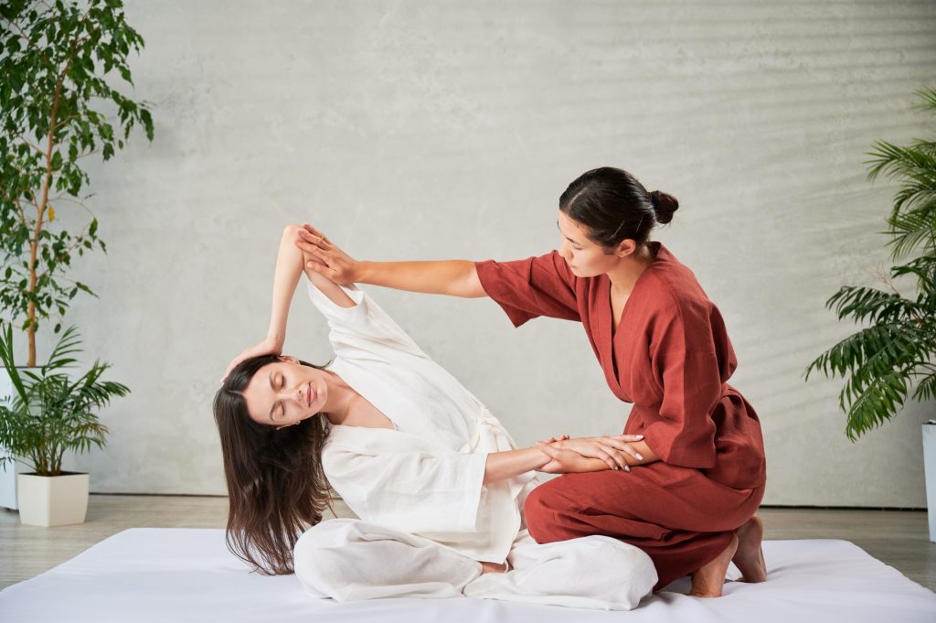masseuse,making,thai,yoga,massage.,woman,therapist,doing,traditional,massage