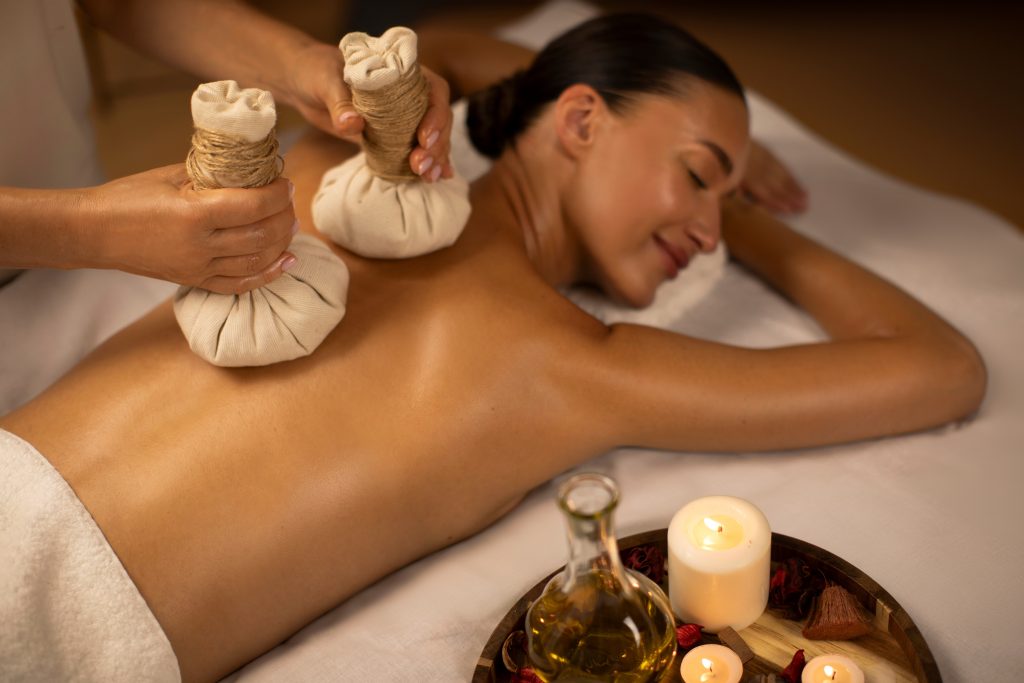 lady,receiving,hot,herbal,ball,spa,massage,body,treatment,,masseur